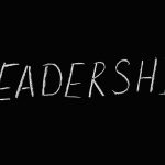 Chalk text spelling 'Leadership' on a blackboard, symbolizing guidance and authority.